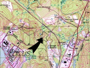 A dard arrow and an outlined location on a topographic map