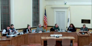 a group seated behind desks