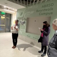 School District Energy Manager Kate Crosby leads visitors on a tour of the Boardwalk School.