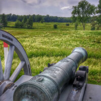 Revolutionary War era cannon aimed towards a field