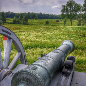 Revolutionary War era cannon aimed towards a field